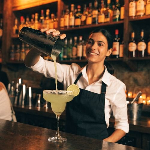 Bartender pouring a fresh margarita