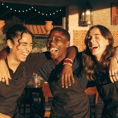 Happy Arturo's team together in the dining room